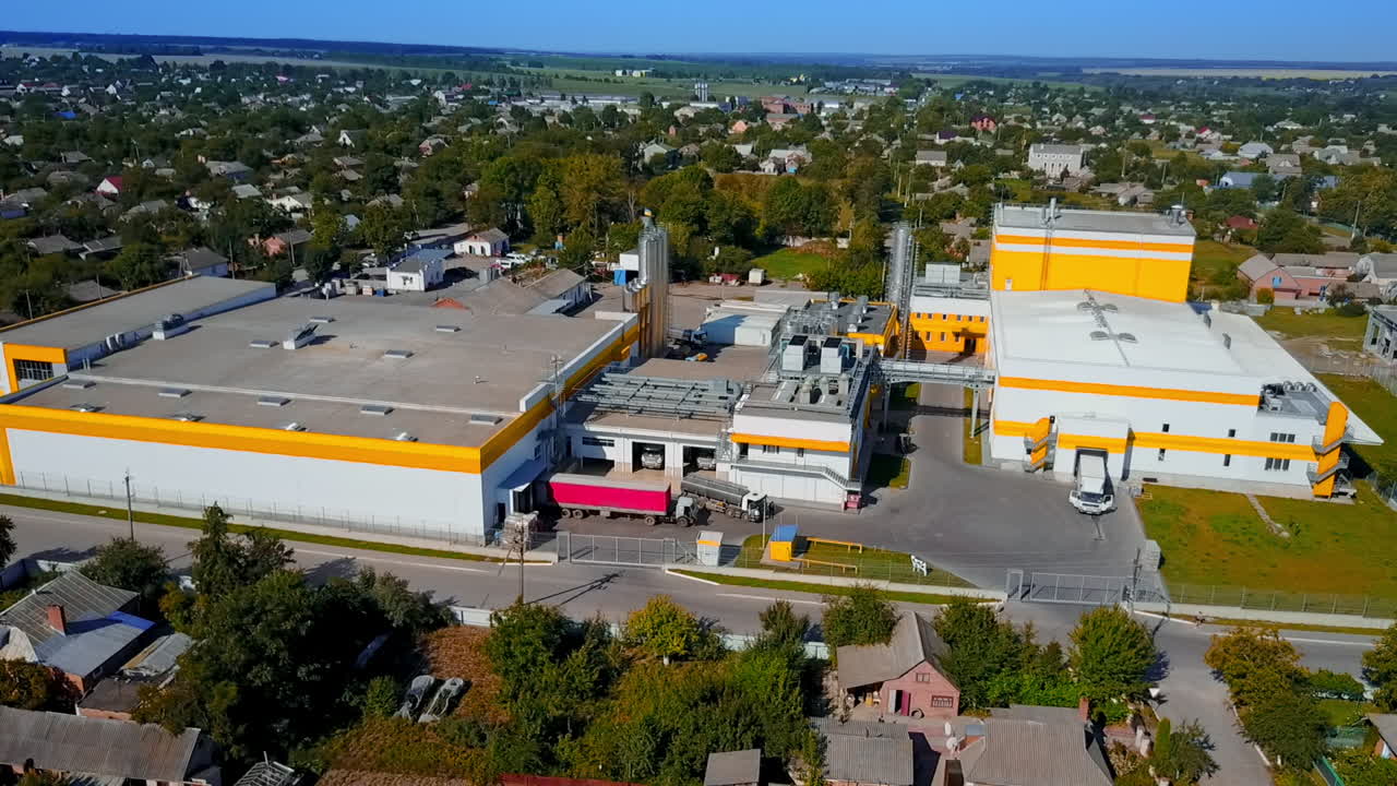 Nice territory of a new industrial plant located in the rural area. Drone footage over the landscape on sunny day.