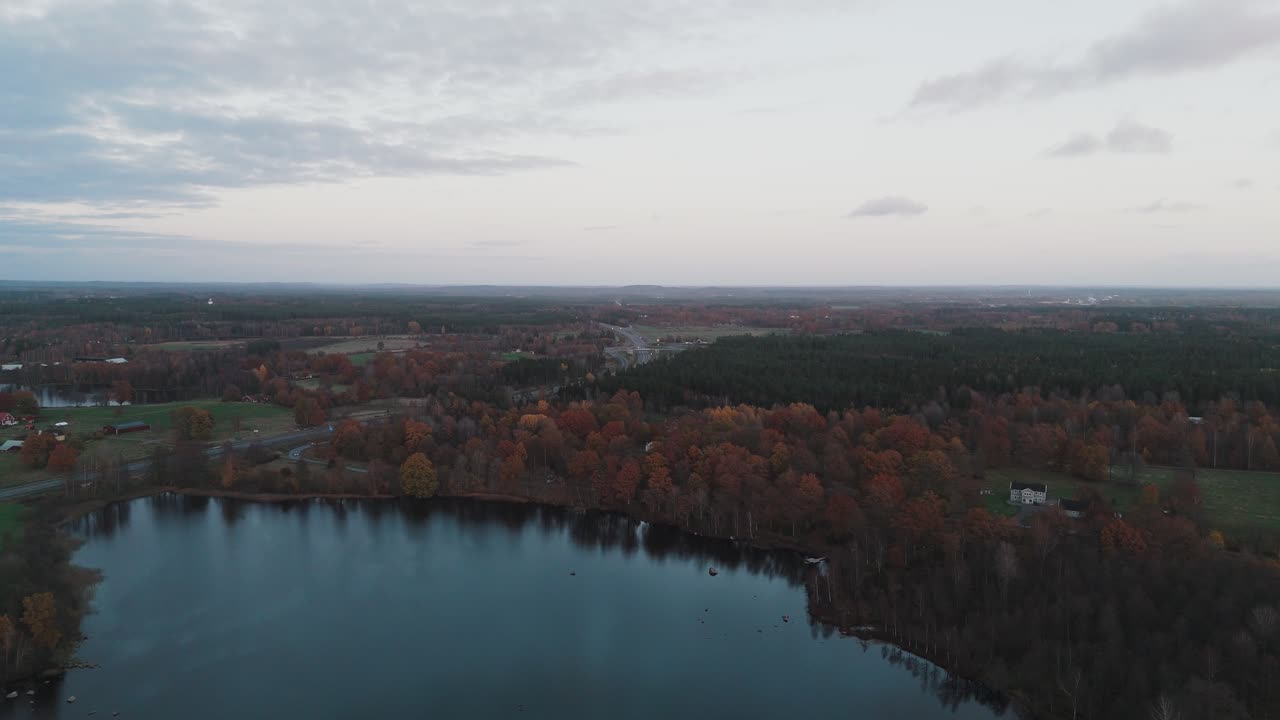 Countryside of Sweden in Autumn, Golden Hour, Lake by the Highway to Värnamo - Aerial Drone Shot