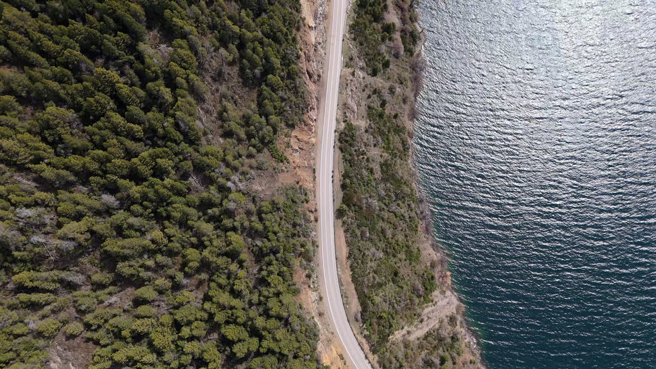 Top-down aerial shot of Route 40 with Lake Lacar, Argentina, in a stunning bird’s-eye view.