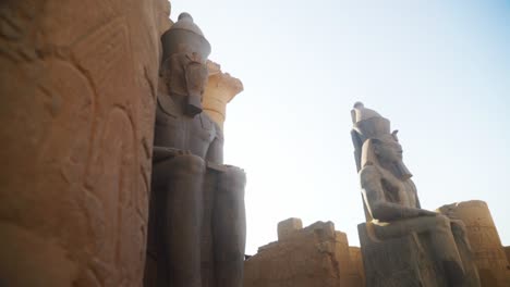 tall statues in the karnak temple, luxor egypt. intricate carved drawings and hieroglyphs adorning the wall.
slow slide movement sideways.