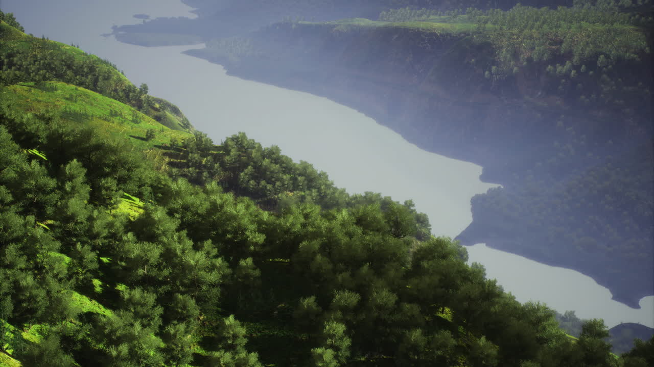Lush green hills overlooking a serene river in a tranquil natural landscape