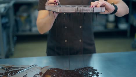 girl-strains-chocolate-glaze-through-special-fine-sieve