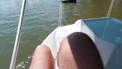 pov male hairy feet kicking paddleboat on lake