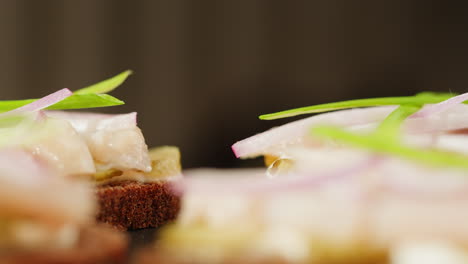 close-up of smoked fish and onion canapes
