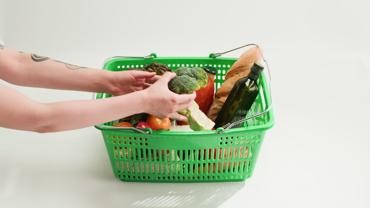 Person placing groceries in a shopping basket
