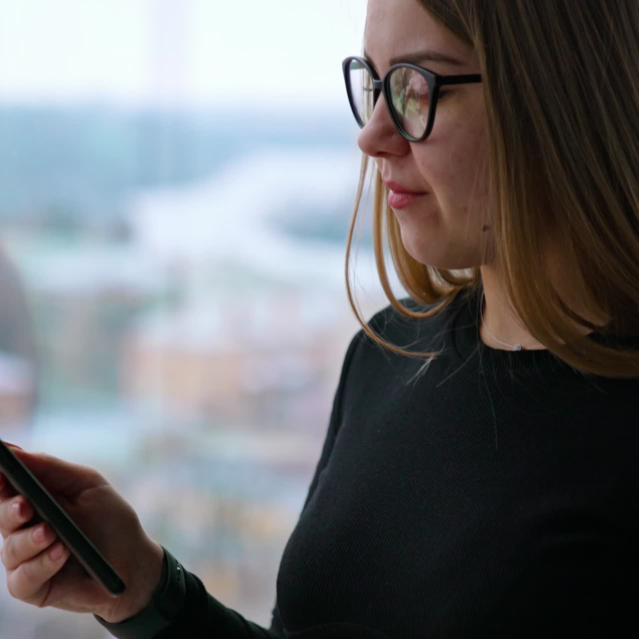 Beautiful woman wearing eyeglasses using cellphone and drinking coffee