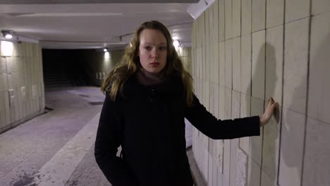 girl walking in the underground passage at night time