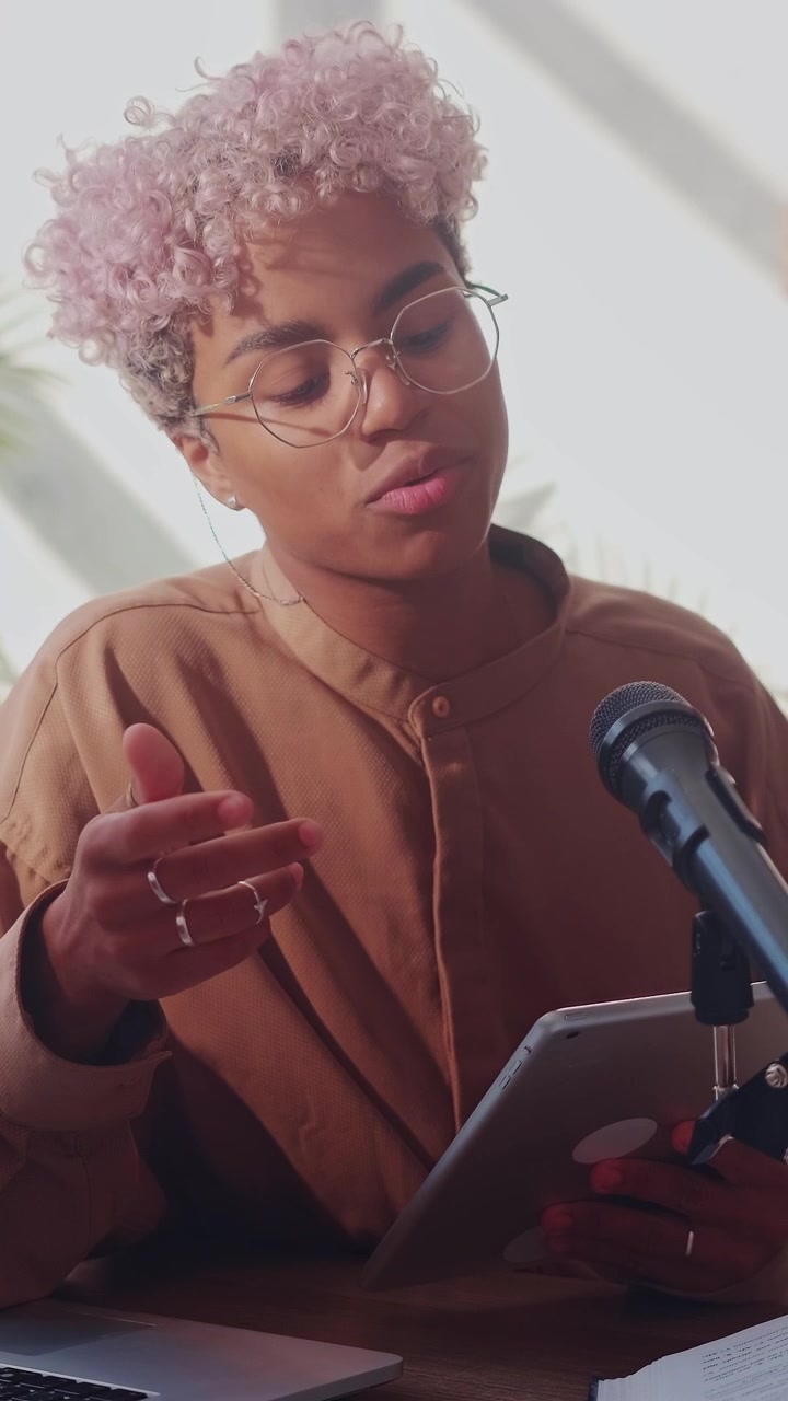 Young african american teacher uses a tablet to manage her online lesson