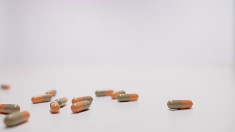 scattered pills and capsules on white background