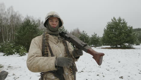 german soldier with machine gun in winter landscape