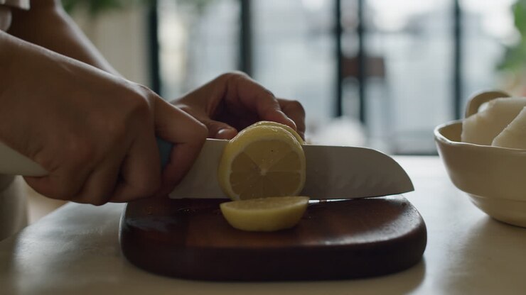 Person Cutting a Lemon