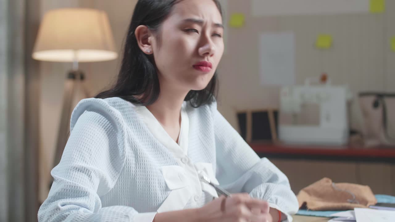 사무실에서 레이아웃을 그리는 동안 생각하는 아시아 여성 디자이너의 클로즈업