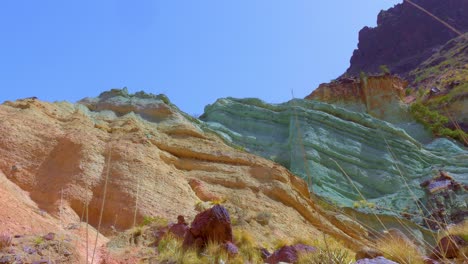 bottom view of colorful rocky wall in desertic area