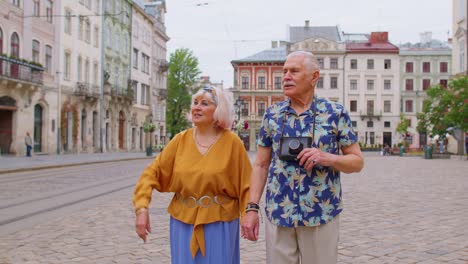 Senior-old-stylish-tourists-man,-woman,-grandmother,-grandfather-family-having-a-walk-in-summer-city