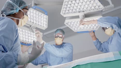 focused diverse male and female surgeons with face masks during surgery in slow motion, unaltered