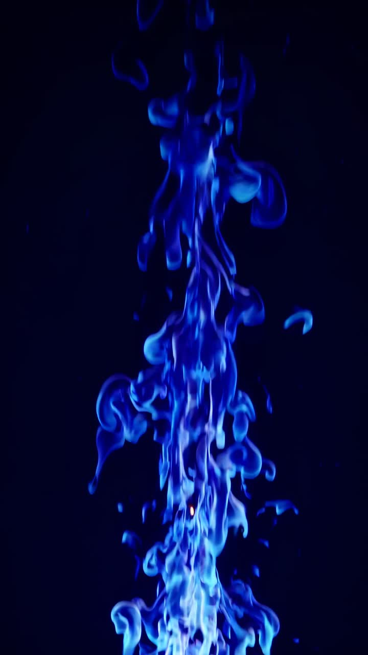 A dynamic video capture of blue flames rising against a dark background, shot from a low angle