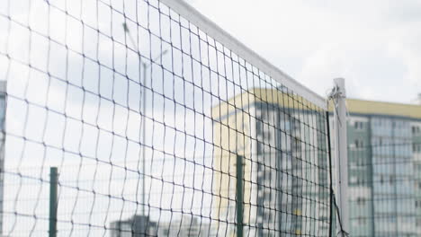 volleyball net and and buildings in the background