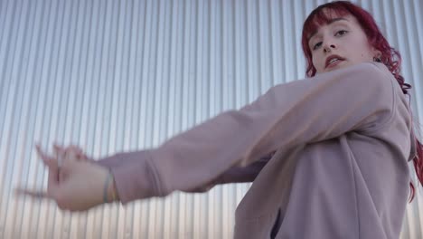 young urban dancer performing modern choreography in city setting