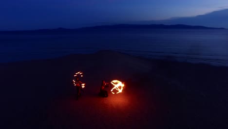 dancing fire show on the sandbanks beach at sunset