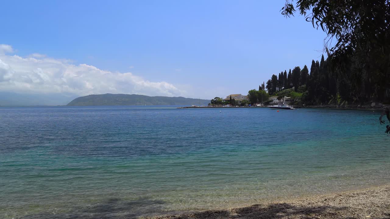 View from Kouloura beach of the bay and fishing harbour, Corfu, Greece