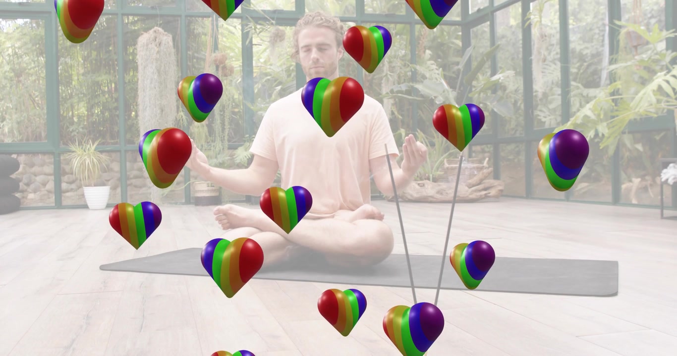Yoga matında bağdaş kurmuş oturan adam, etrafında yükselen 3D gökkuşağı kalpler, sağlıklı yaşam meditasyonuna rehberlik ediyor