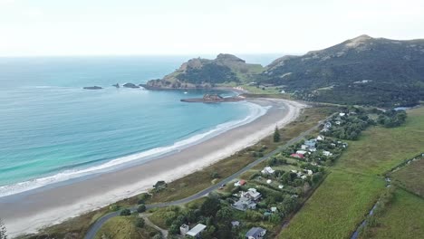 aerial shot - flying over the medlands beach in great barrier island, new zealand