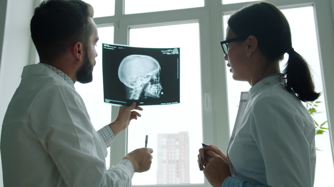 Doctors reviewing a skull X-ray