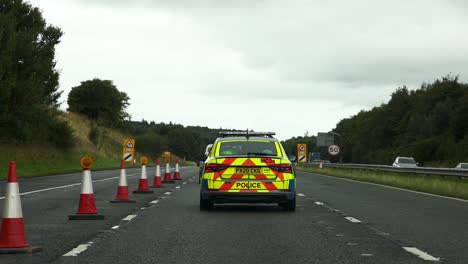 police car navigating through road cones