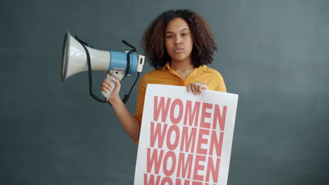 Young Woman Holding Protest Sign and Megaphone