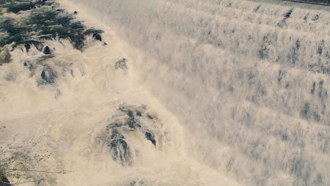 White water rushing down New Croton Dam stepped spillway and gorge waterfall. Static shot, Slow motion 40 fps