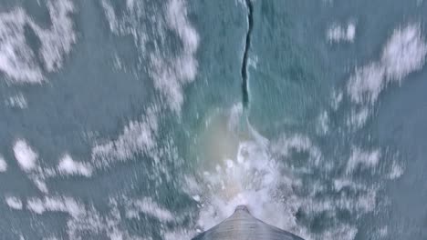 Tilt-up-bow-point-of-view-of-an-icebreaker-ship-plowing-through-sea-ice-in-Hinlopen-Strait-in-Svalbard-Archipelago-Norway