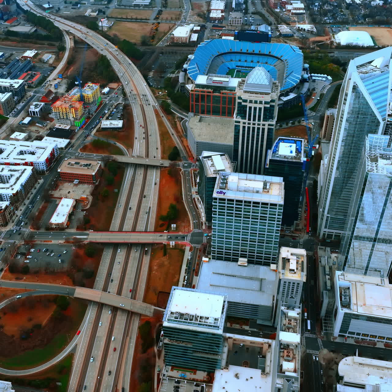 Cityscape of American city of Charlotte in North Carolina. Wide lane highway leading to city center. Top view.