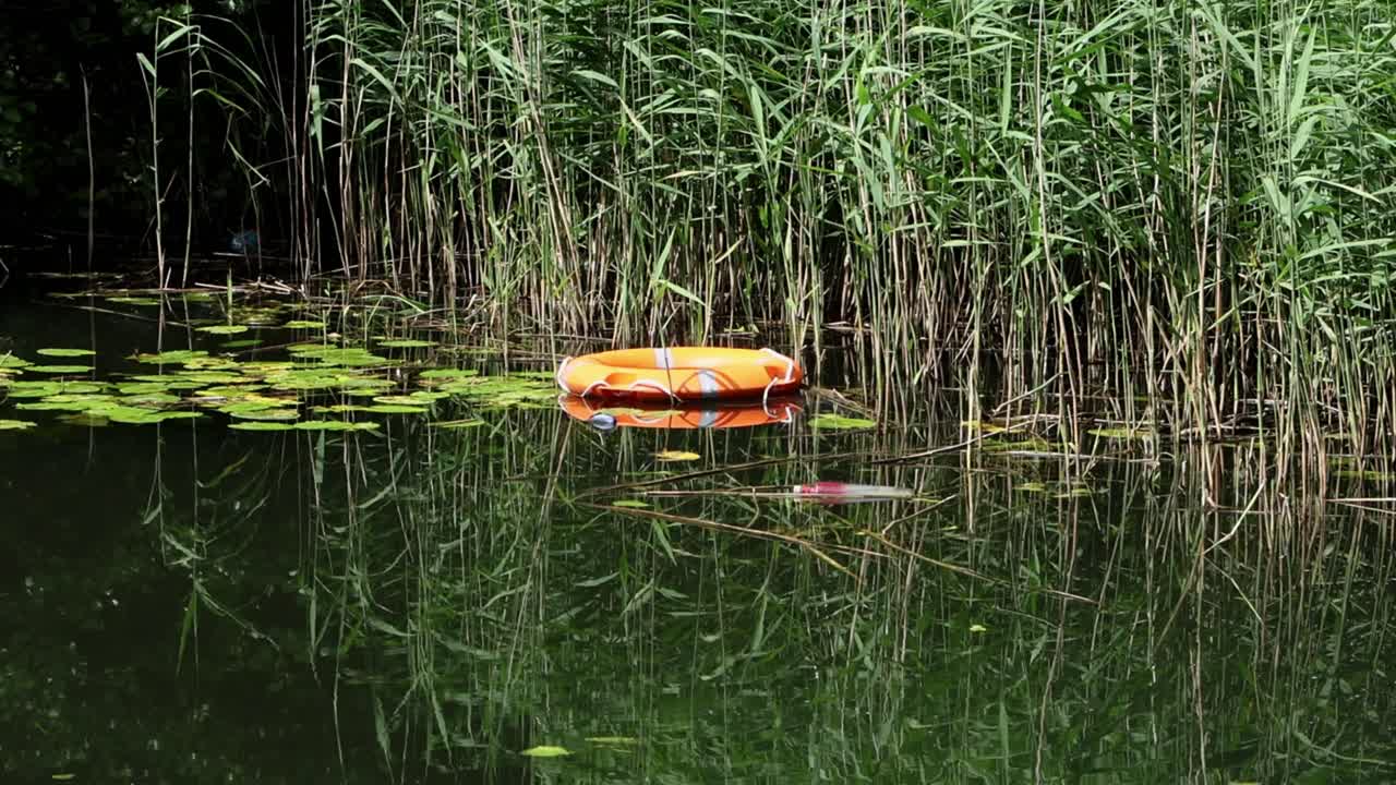 A life belt floating at edge of lake. Staffordshire. UK