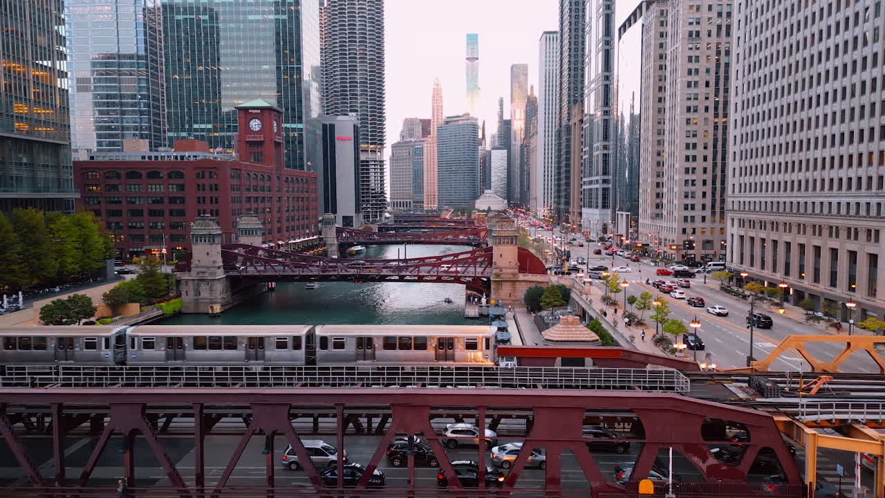 Chicago, USA, 29 June 2025: Long train crossing the Chicago River by the bridge. Downtown of Chicago from drone