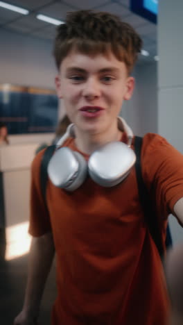 teenager taking a selfie at the airport