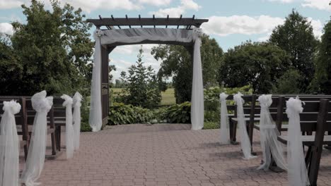 gorgeous outdoor stone patio wedding ceremony are at the strathmere events center during a beautiful sunny blue sky day