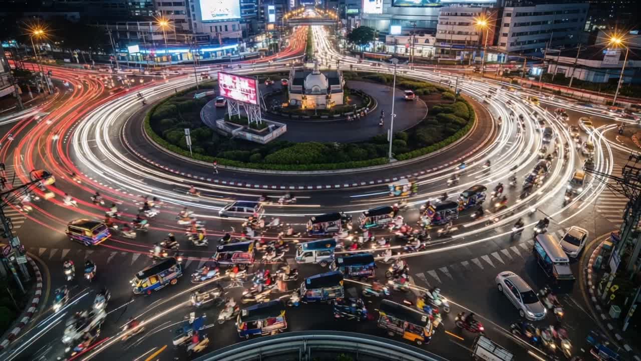 Dynamic Urban Intersection: Capturing the Flow of Traffic in a Circular Route at Night with Energetic Light Trails and Busy Road Activity