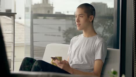 Man-using-mobile-phone-while-having-coffee-at-home-4k