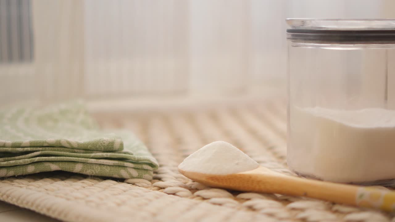 Baking Soda in Glass Jar and Wooden Spoon