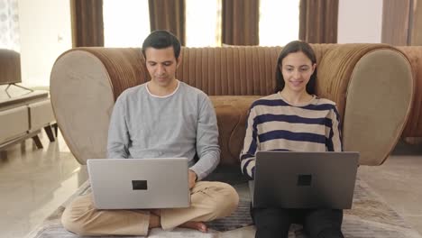 Happy-Indian-couple-working-on-laptop