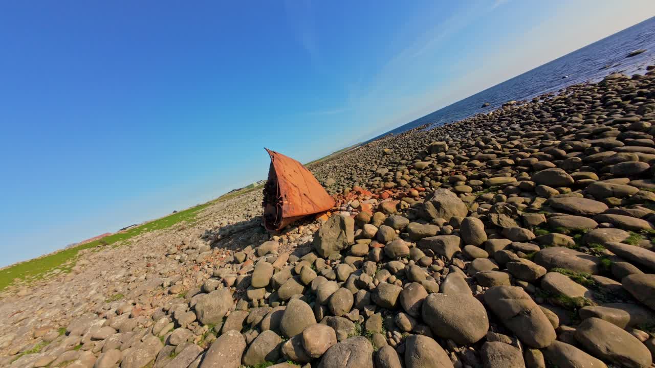 Fast-paced FPV drone orbit of a rusty shipwreck on Rogaland’s rugged coast in Norway. Dramatic aerial movement around the corroded bow in a striking maritime setting.