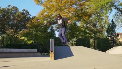 skateboarder does a halfcab crooked grind on a hubba