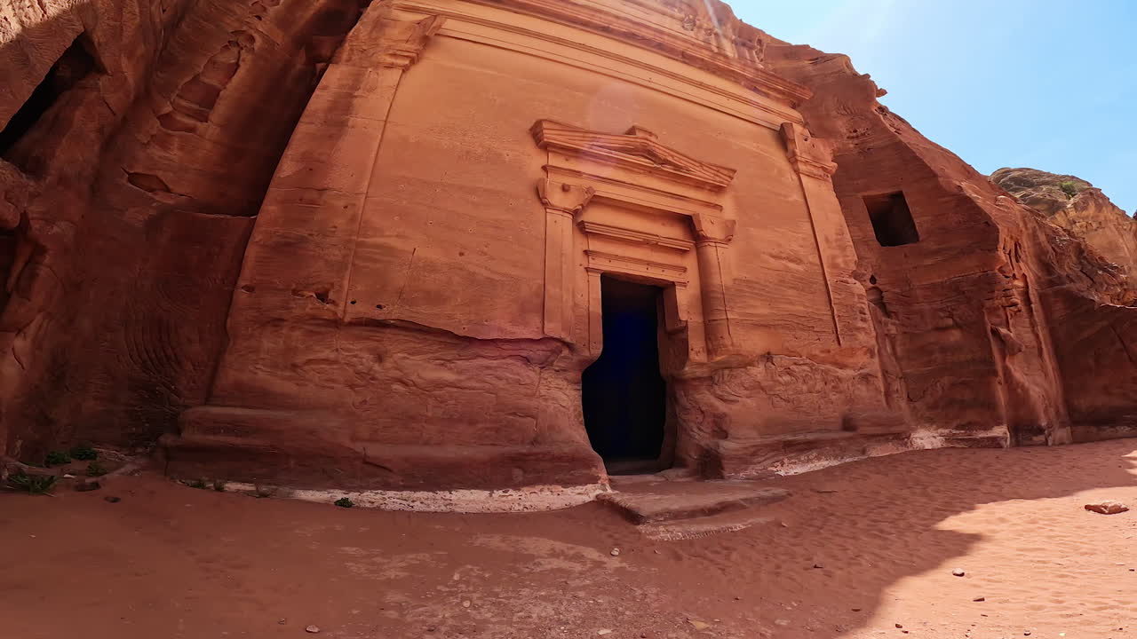 Madain Saleh tomb from the Nabatean era. Low angle view at the stone-cut facade of a temple in Petra, Jordan, West Asia.