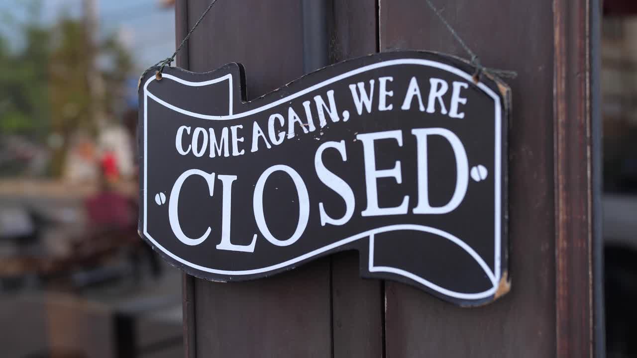 Closed Sign on a Wooden Door