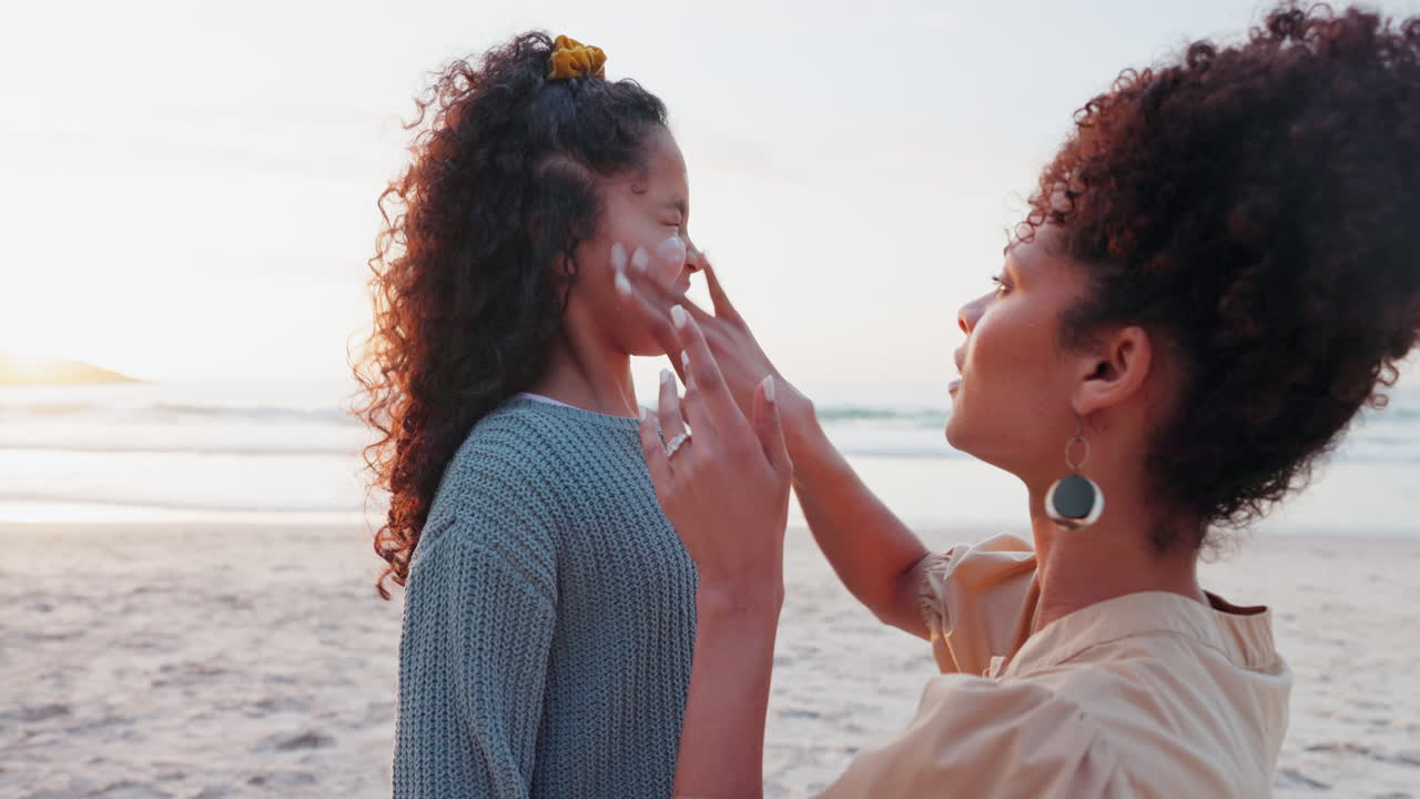 Beach, sunscreen and application by mother