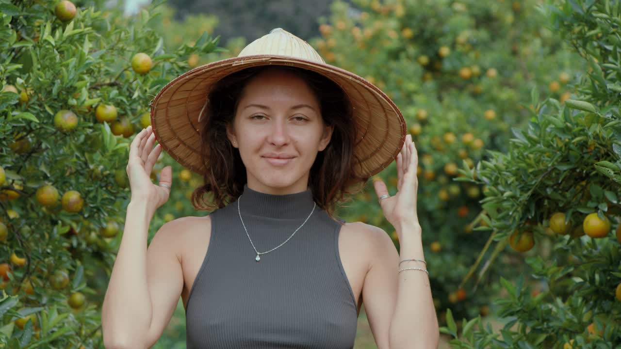 Woman in Straw Hat in an Orange Orchard