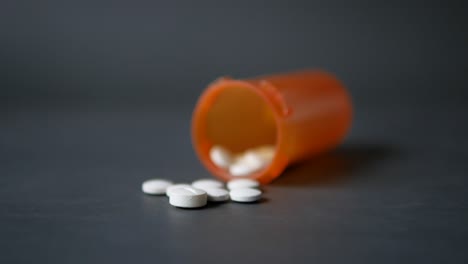 orange pill bottle with white pills