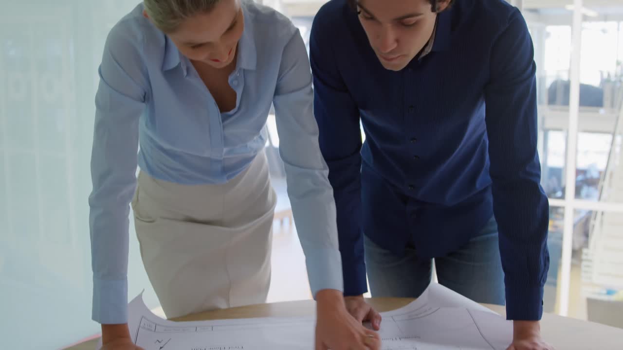 hombre y mujer jóvenes trabajando en una oficina creativa