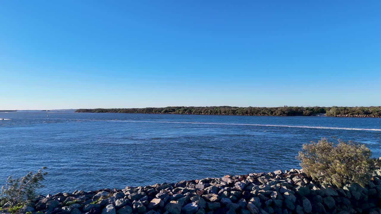 Drone captures serene Gold Coast seaway with boats, calm waters, and vibrant sunset hues in an 11-second aerial view