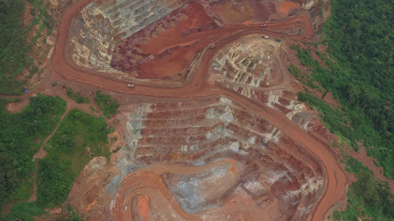 Open pit bauxite mine aerial view with trucks transporting ore